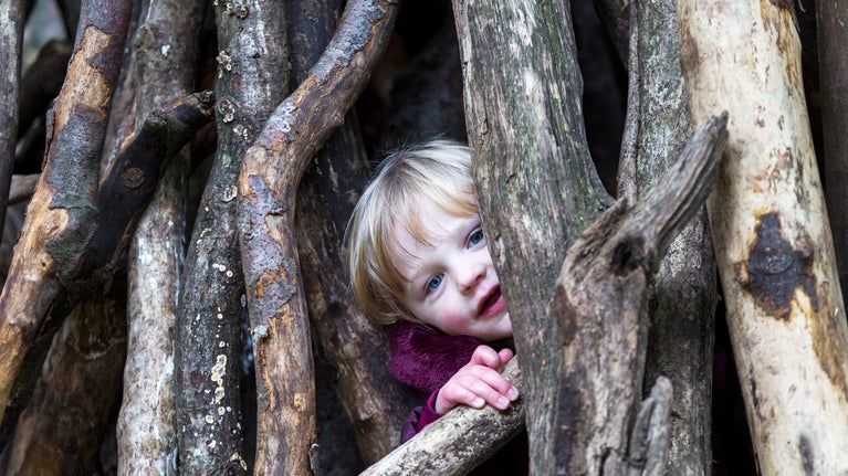 child playing in the natural play area